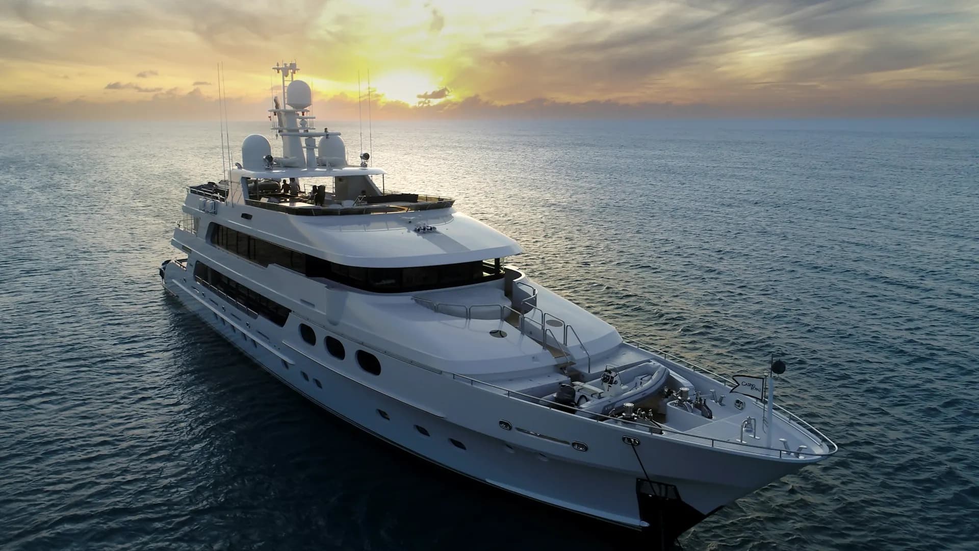 A superyacht at sea off Dubai during golden hour