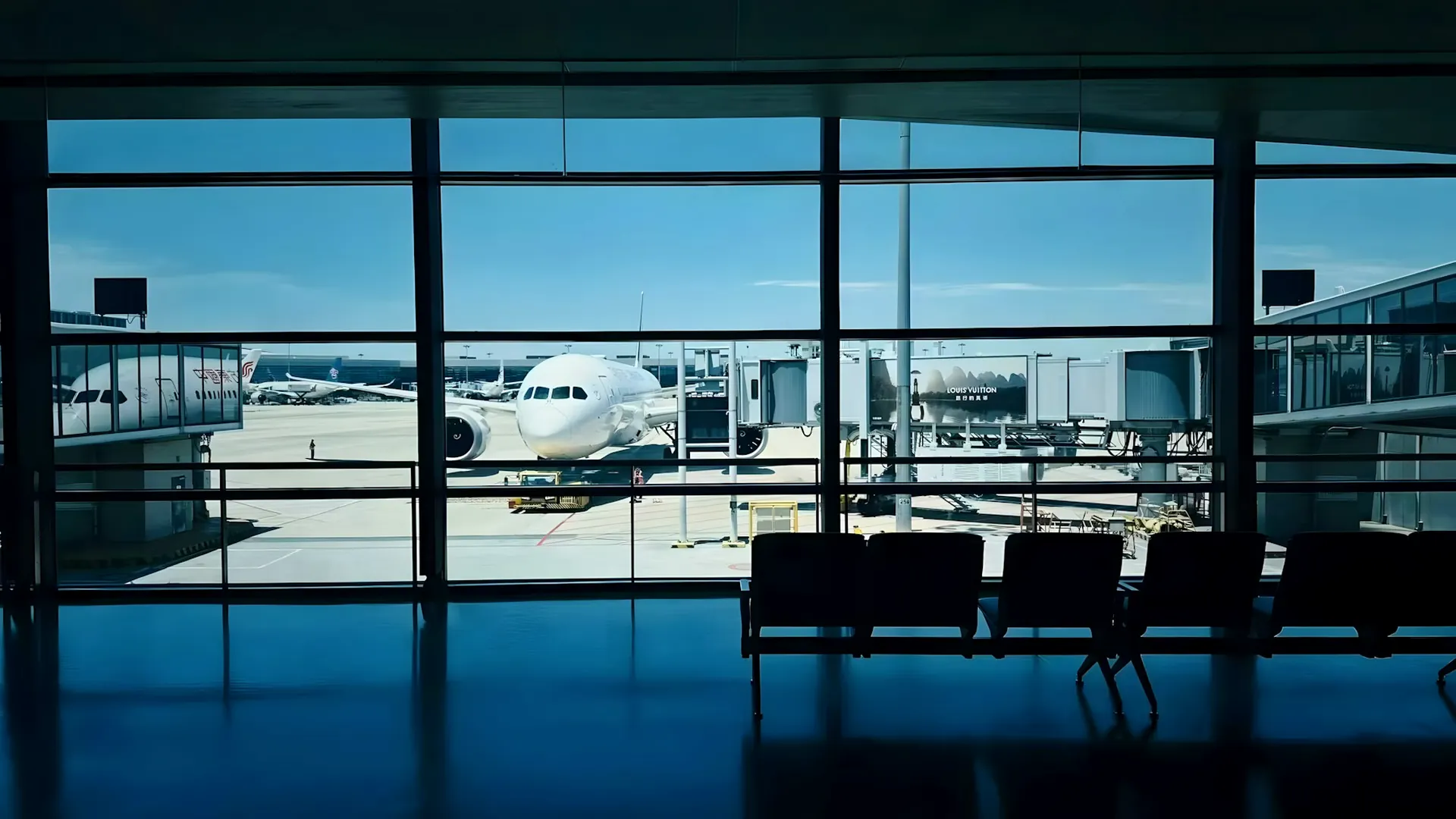 Aircraft on the tarmac seen through the glass of an airport terminal