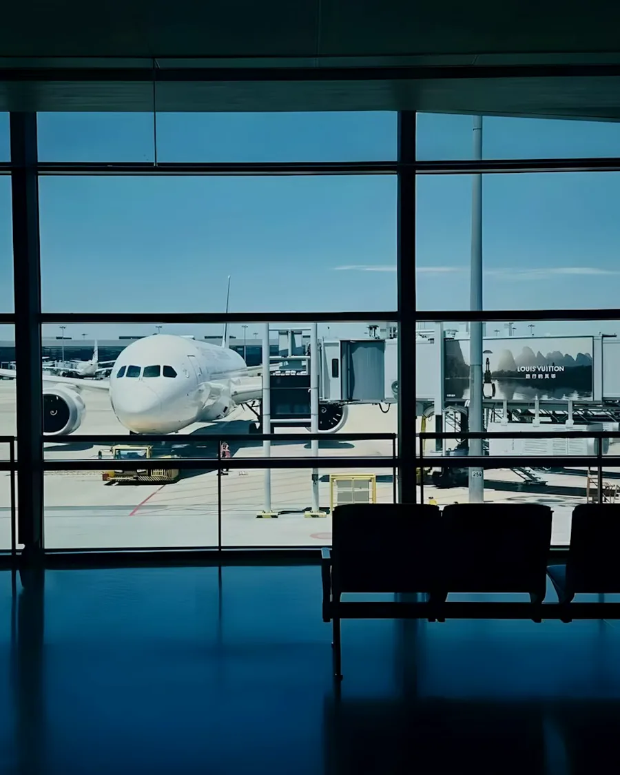 Aircraft on the tarmac seen through the glass of an airport terminal
