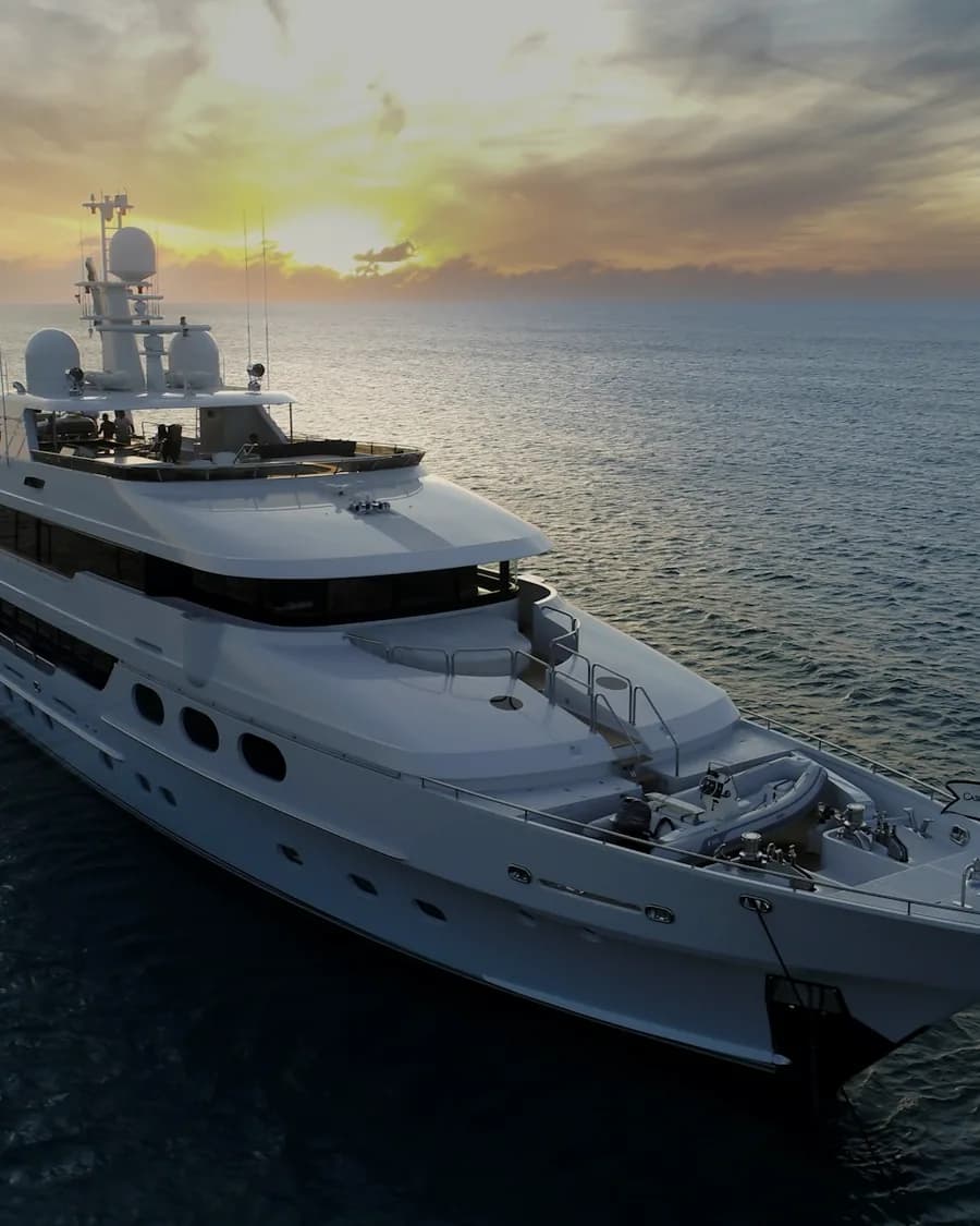 A superyacht at sea off Dubai during golden hour
